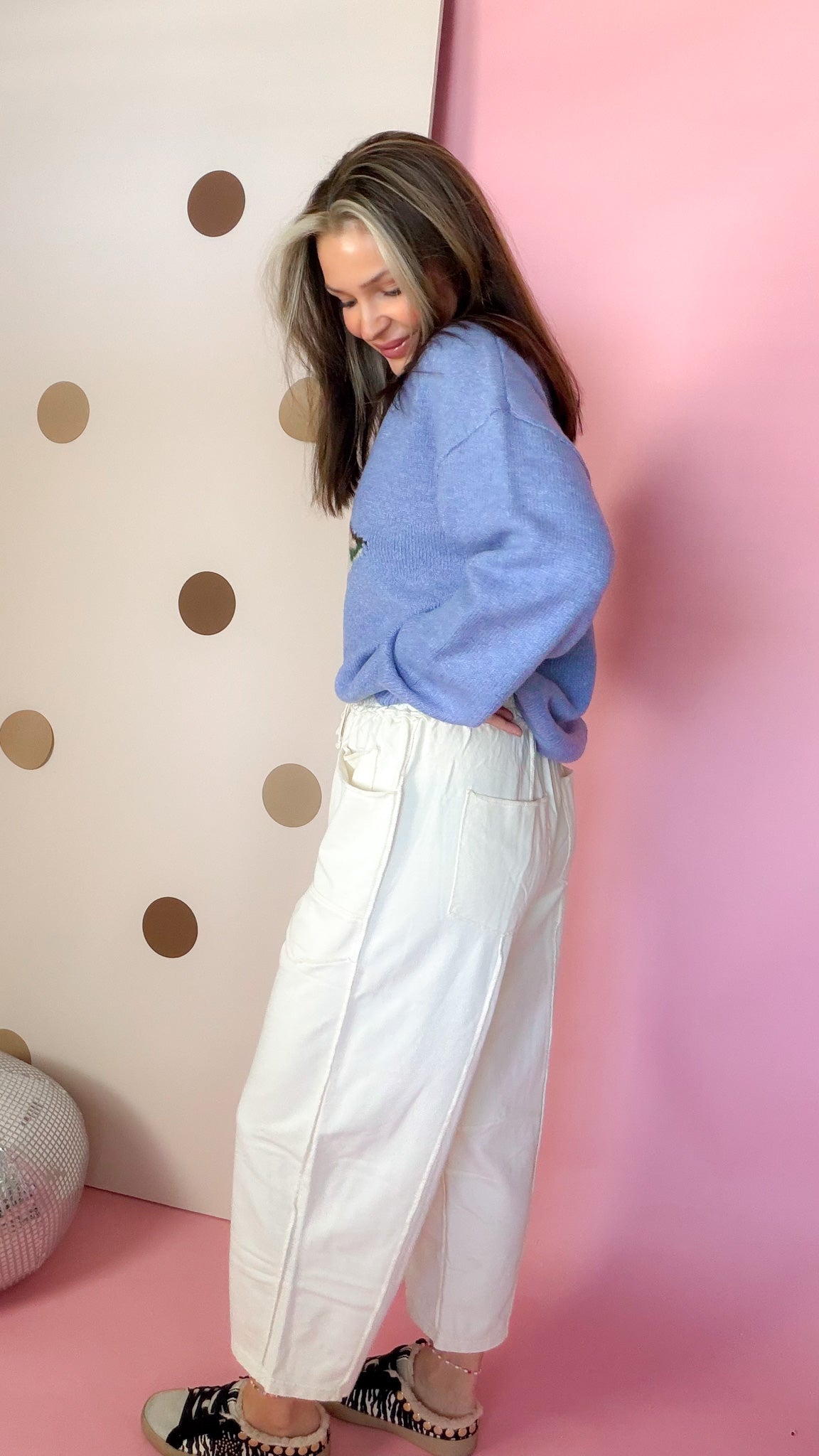 Side view of Ecru mineral wash barrel pants showing the relaxed leg shape and patch pocket detail.