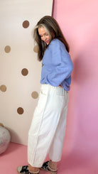 Side view of Ecru mineral wash barrel pants showing the relaxed leg shape and patch pocket detail.