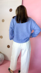Back view of Ecru cotton barrel pants showing large back patch pockets and exposed seams.