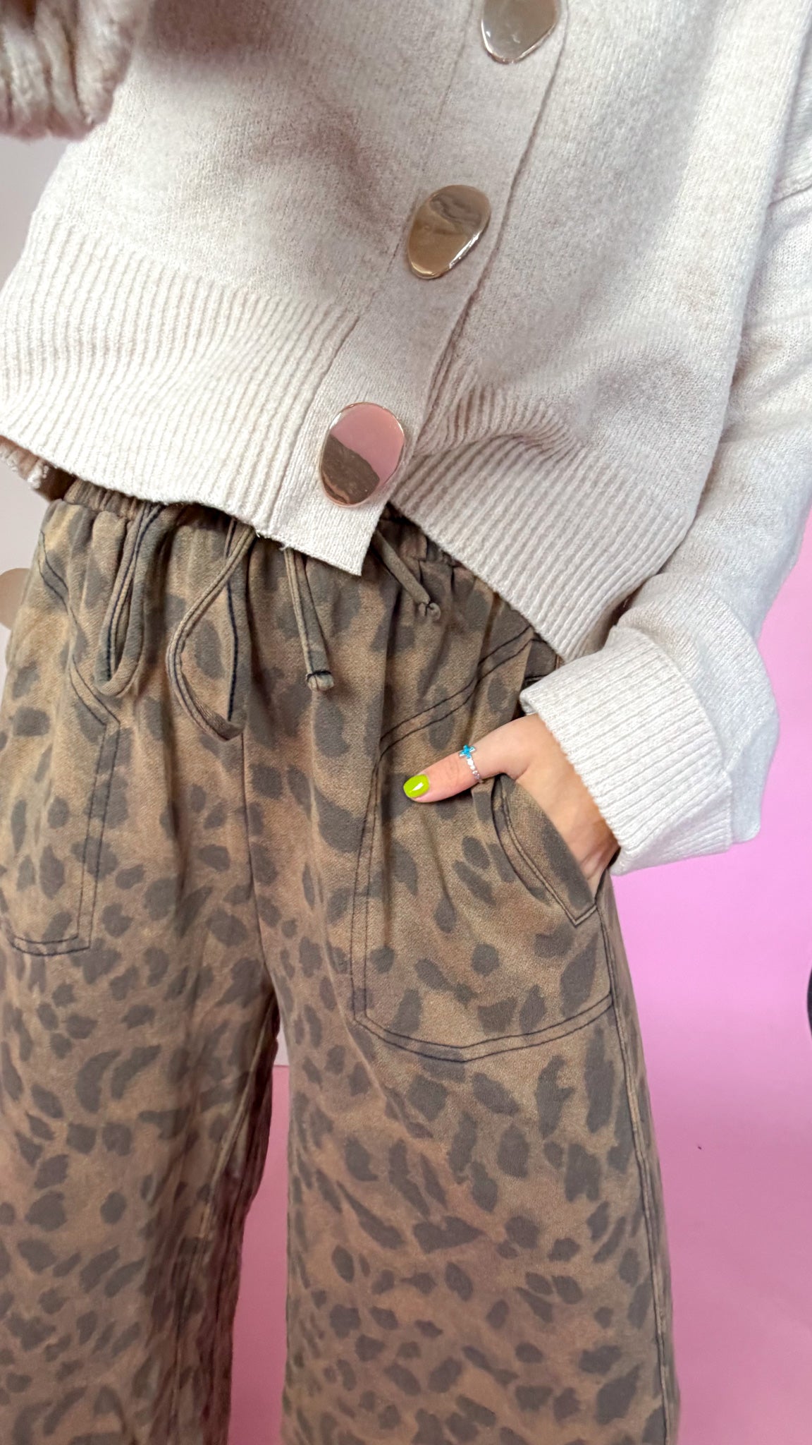 Detail of the mocha leopard pants showing the drawstring waistband, stitched pocket and mineral-washed print.