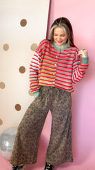 Mocha leopard wide leg pants paired with a colorful striped cardigan and black high-top sneakers.