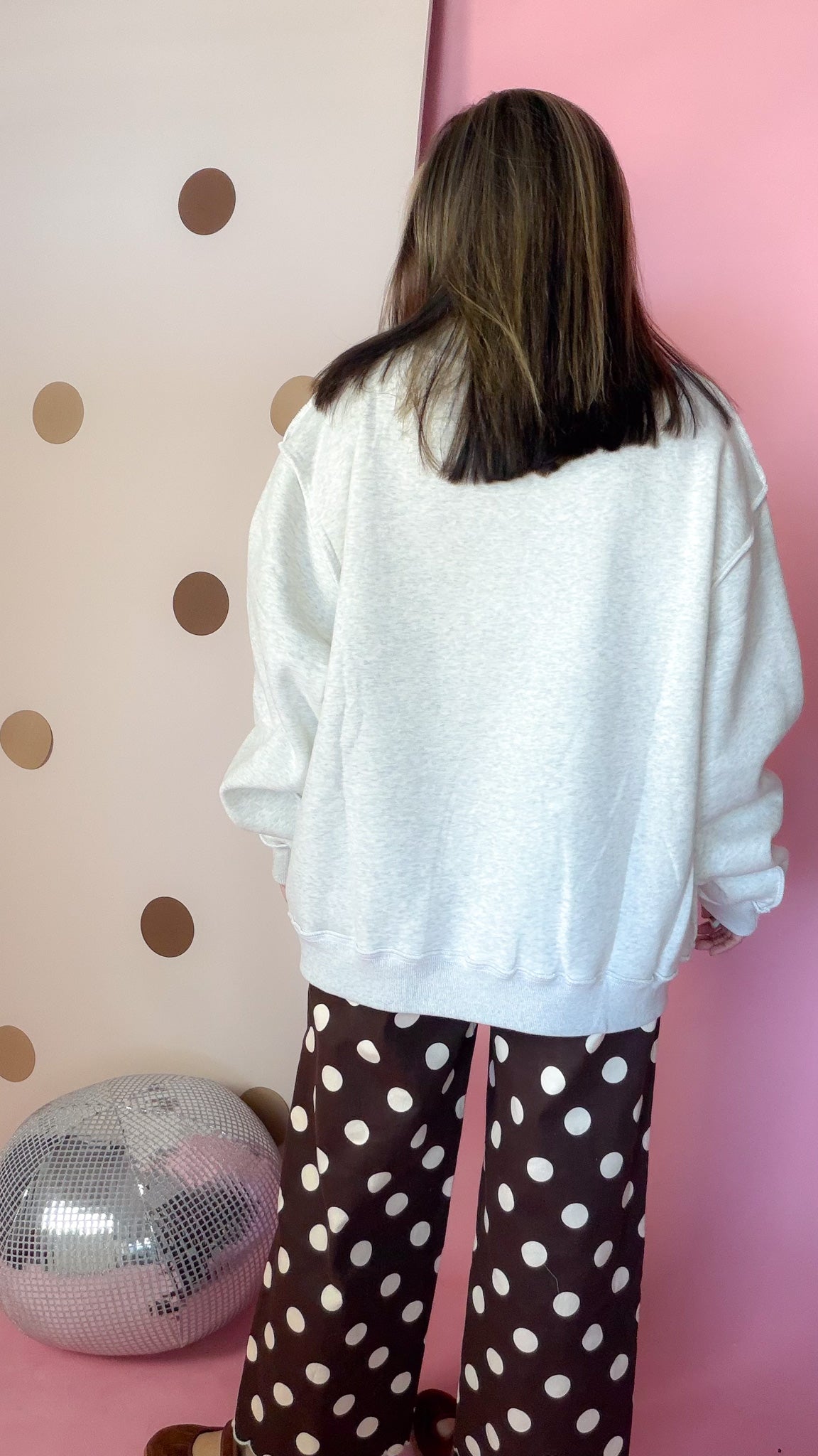 Back view of ash grey mock neck sweatshirt showing dropped shoulders, long sleeves and ribbed hem