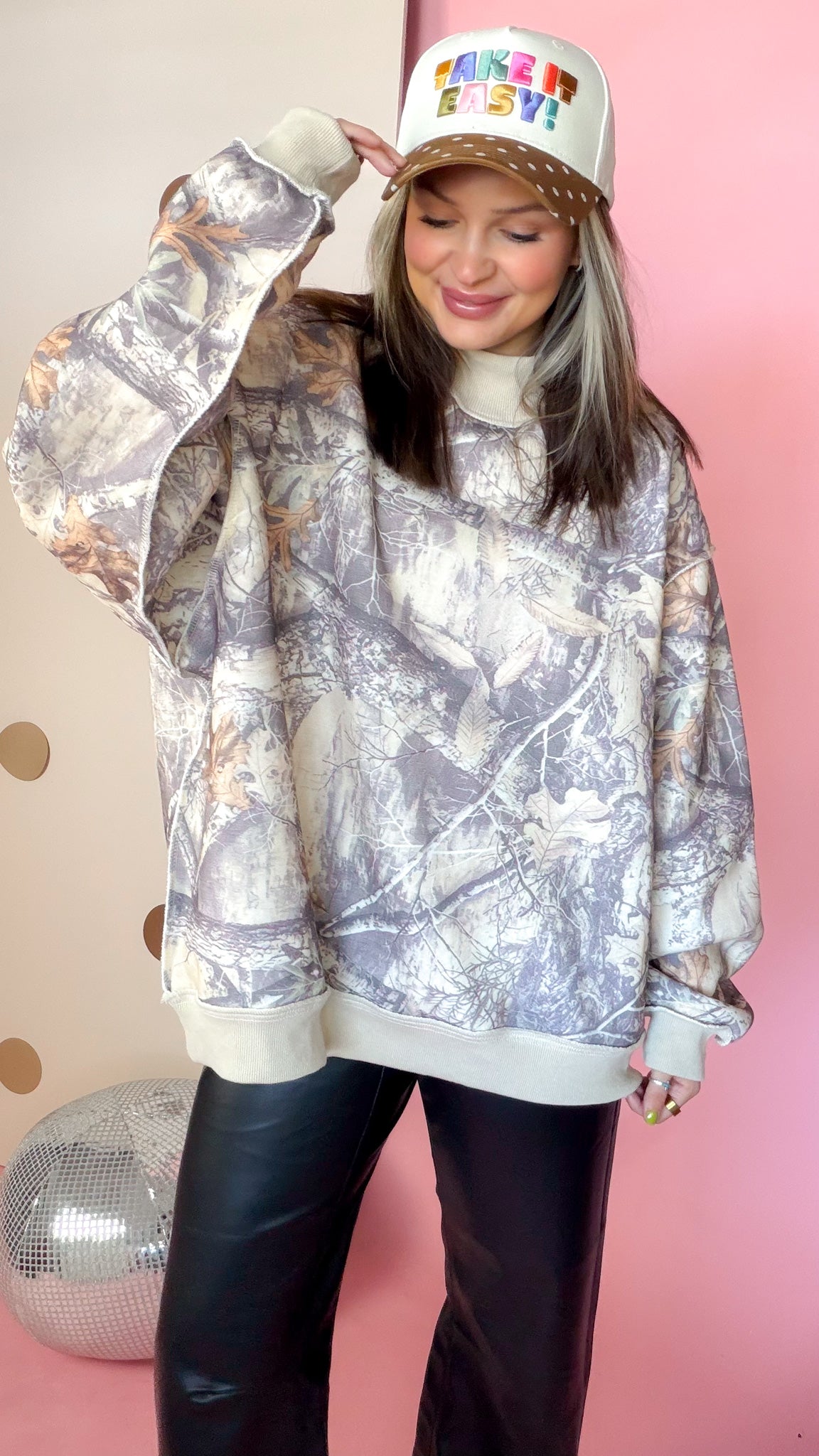 Close front view of taupe Real Tree camo sweatshirt showing mock neck, long sleeves, and light trim.