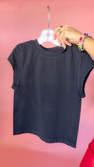Black and white solid tees shown together