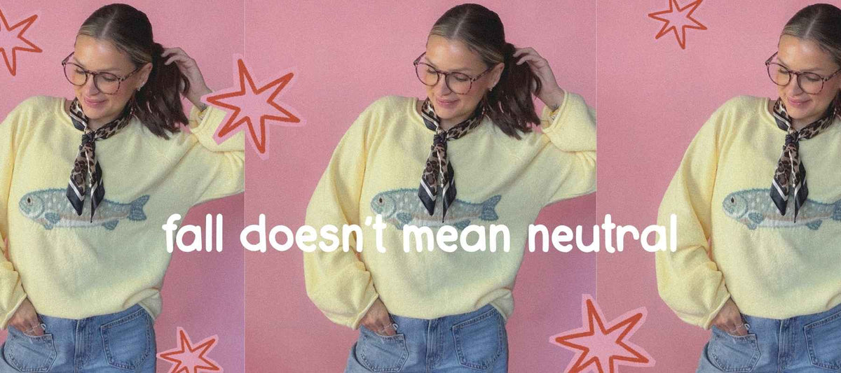 fall doesn't mean neutral quote with image of girl wearing yellow fish sweater paired with leopard neck scarf
