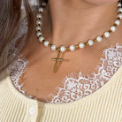 Lolly Pearl Beaded Gold Cross Necklace worn by a model with a lace-trim cardigan