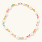 Freshwater pearl stretch bracelet with colorful beads and small gold-tone accents on a light background.