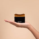 Black Kitsch Lymphatic Contour Face Brush held in an open palm to show its size
