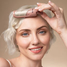 Model placing a terracotta Kitsch Hair Volumizing Clip at her roots for lift