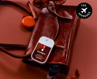 Touchland Cranberry Fizz Power Mist on a red leather bag with TSA approved badge