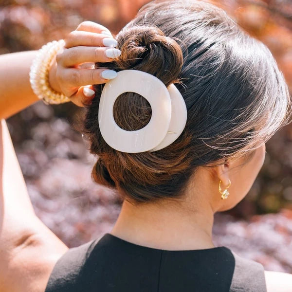 Teleties Almond Beige Large Flat Circle Hair Clip holding a brunette bun