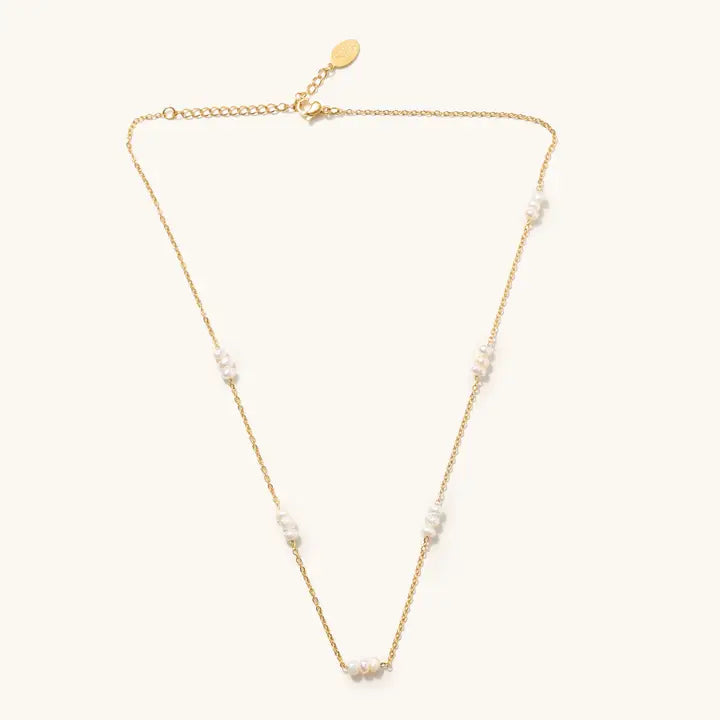 Marina pearl necklace with freshwater pearl clusters along a fine gold-tone chain and extender on a light background.