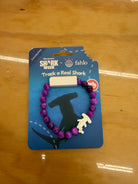 Fahlo Voyage Hammerhead Shark Tracking Bracelet in purple beads with shark charm, on its card