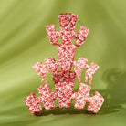 Teleties All Tied Up red bow print claw clips in a stack on green, large size in front