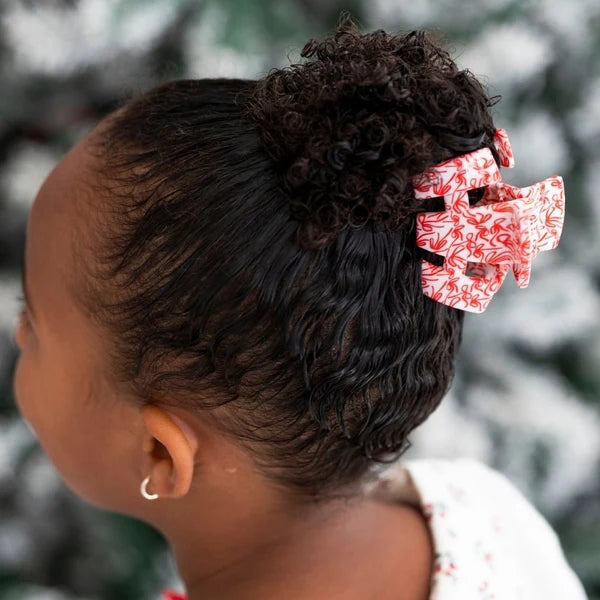 Teleties All Tied Up red bow print petite claw clip in a girl's curly bun