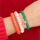 Teleties Clause I Said So small hair ties in red, white and green worn on a wrist