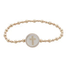 Majesty Tap To Pray bracelet with gold-tone beads in varied sizes and a pale round cross centerpiece on white.