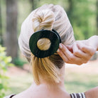 Teleties Jet Black Large Flat Circle Hair Clip holding a blonde twisted updo