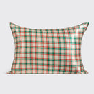 Kitsch holiday plaid satin pillowcase on a pillow, front view