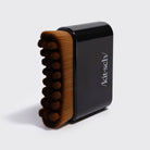 Black Kitsch Lymphatic Contour Face Brush, angled side view of the bristle ridges