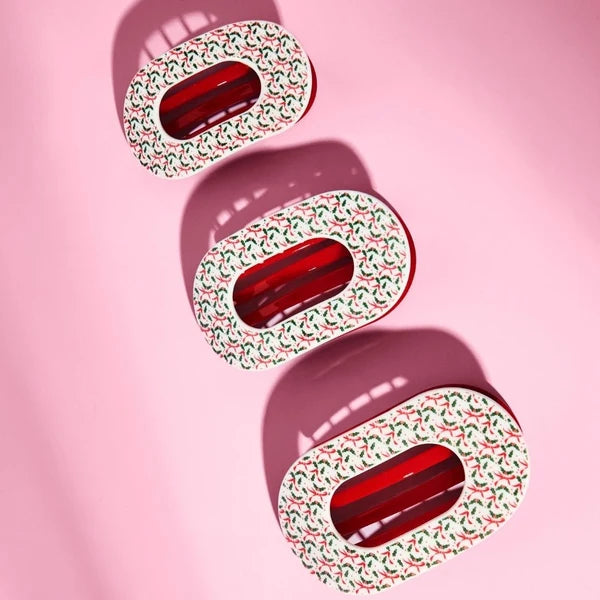 Teleties Festive Feels Flat Round Hair Clips in three sizes on a pink background