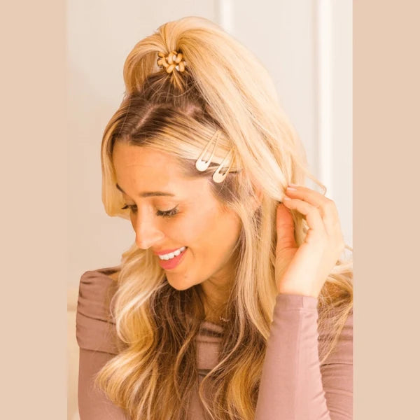 Teleties gold snap clips worn in blonde hair at the side part