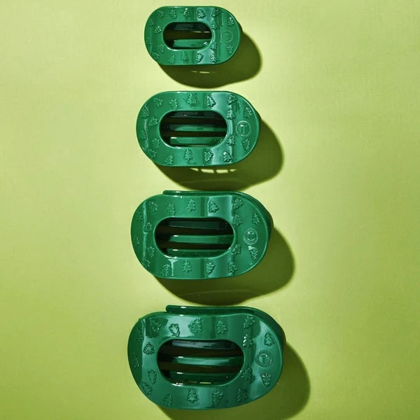Teleties O Christmas Tree Flat Round Hair Clips in four sizes on a green background