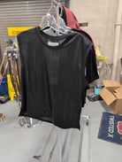 Dear John Charli Onyx Ore top on a hanger, showing the dark metallic-look finish and round neckline.