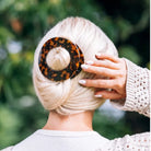 Teleties Large Flat Circle Hair Clip in tortoise holding a blonde low bun