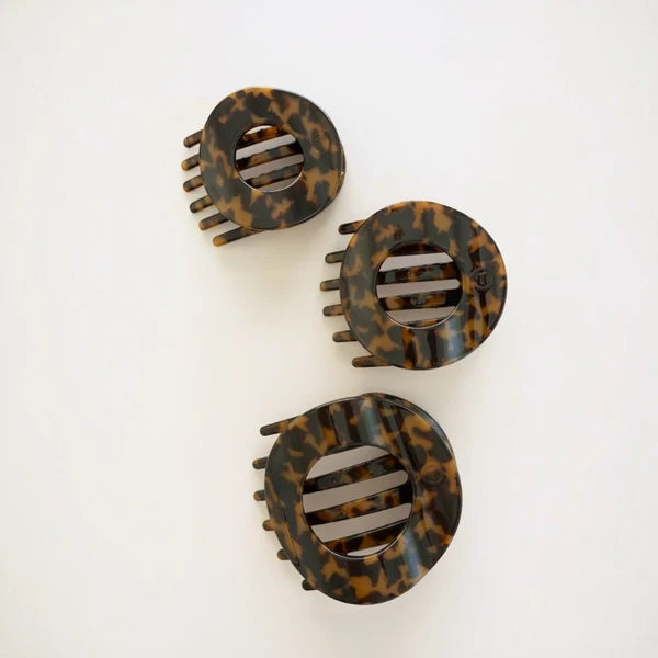 Three Teleties Medium Flat Circle Hair Clips in tortoise on a white surface