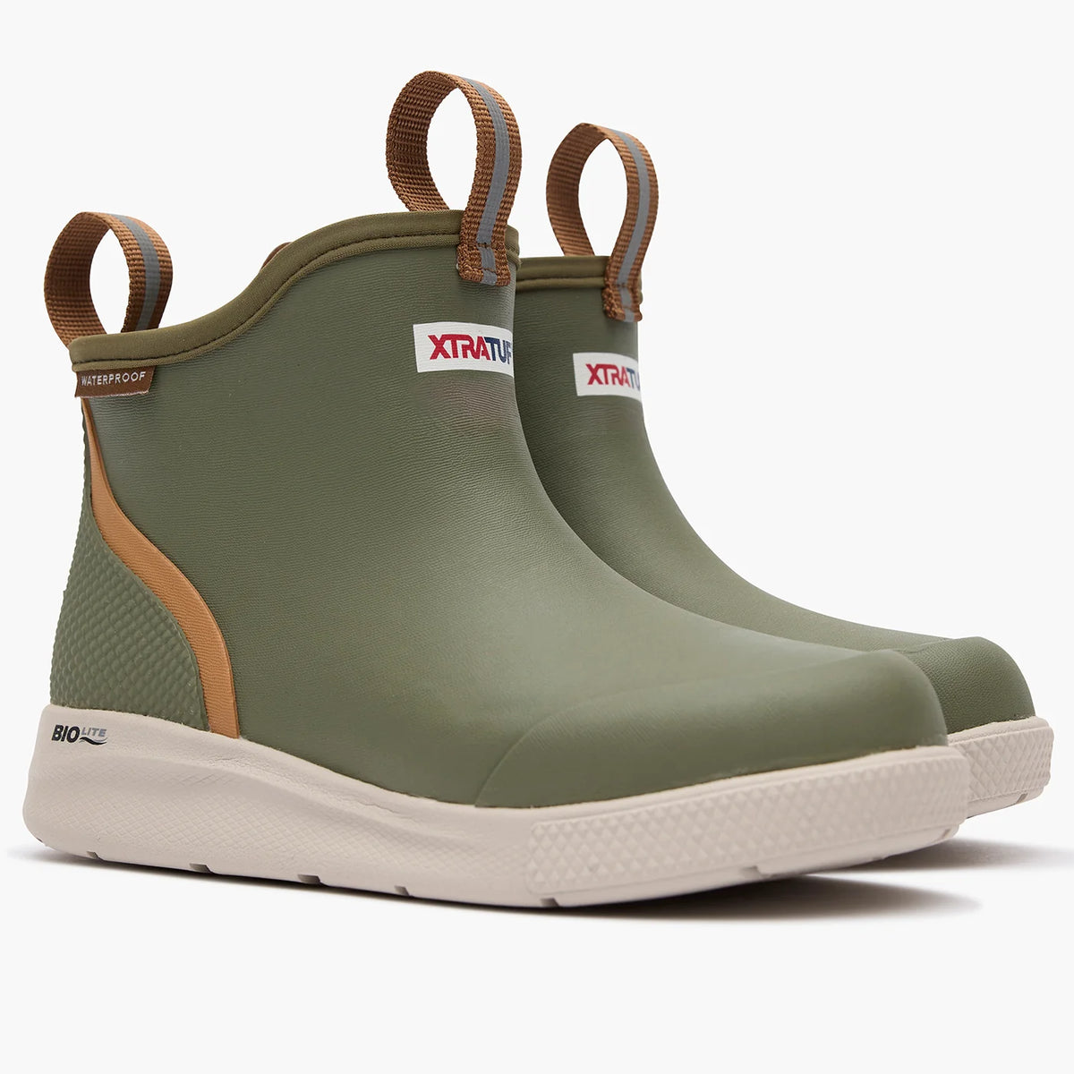 Pair of olive XTRATUF Kids' Ankle Deck Boot Sport boots, angled front view with brown pull loops and light soles.