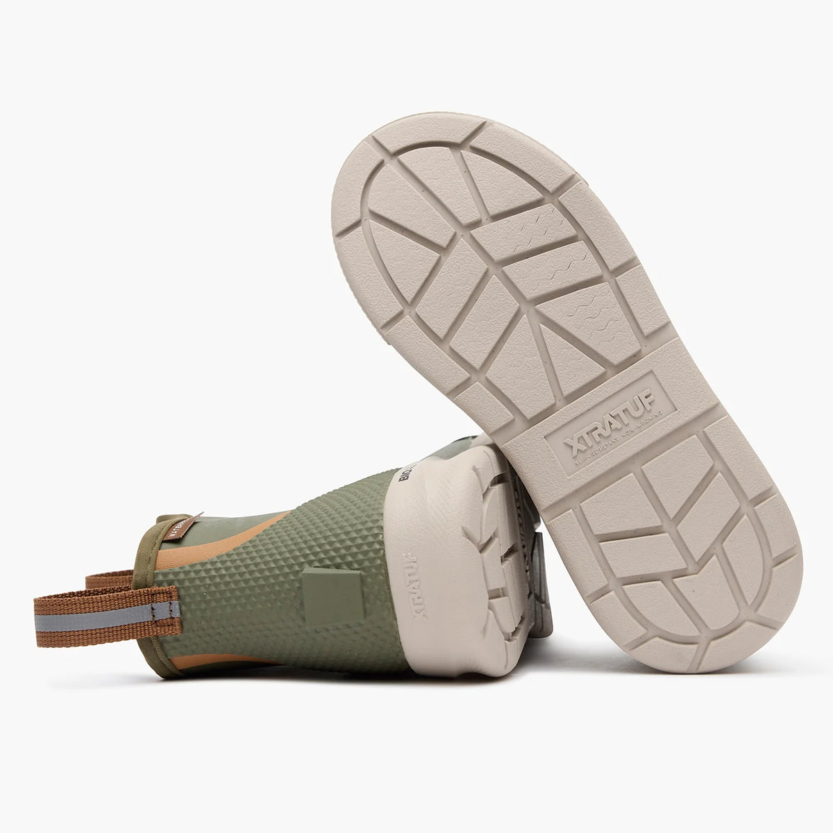 Bottom view of olive XTRATUF kids' deck boots showing the light-colored BioLite outsole and chevron tread.